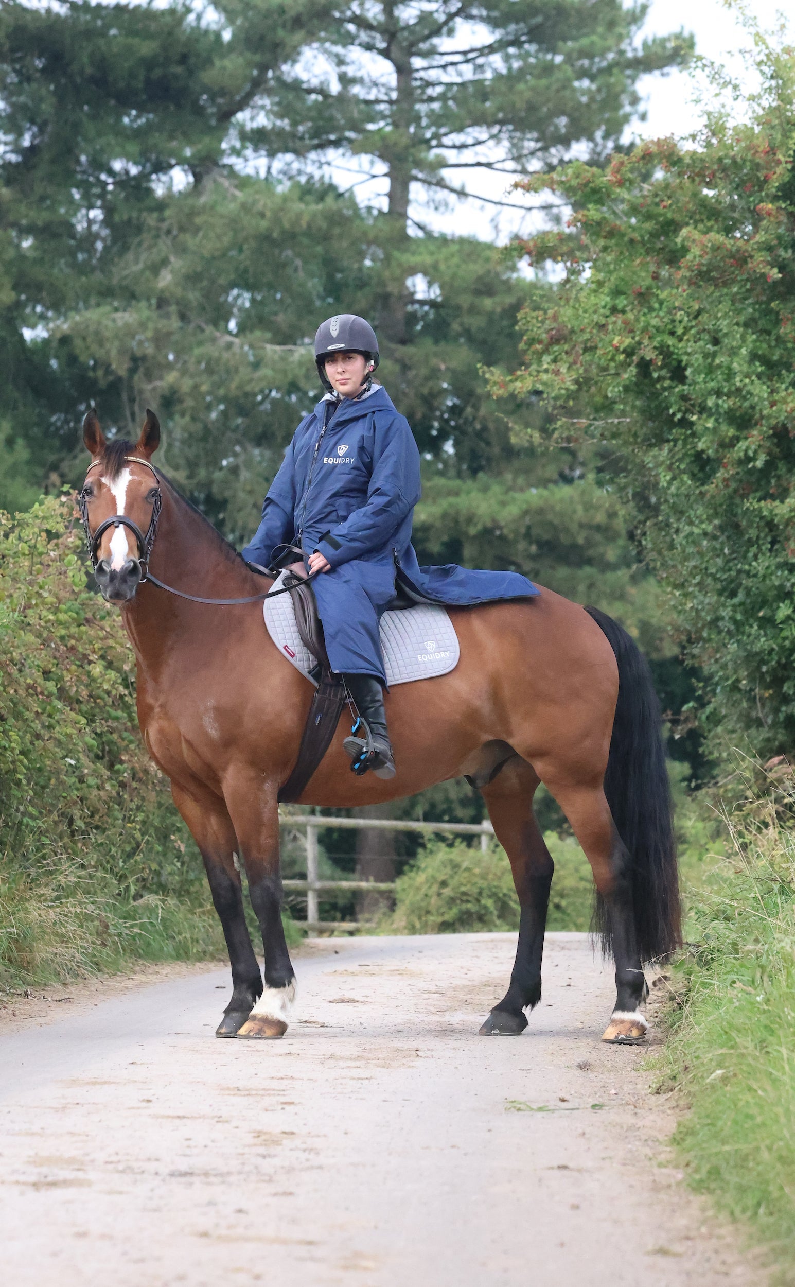 EQUIDRY waterproof horse riding raincoat All Rounder Original thick fleece Women's Navy/Grey rider on horse side view