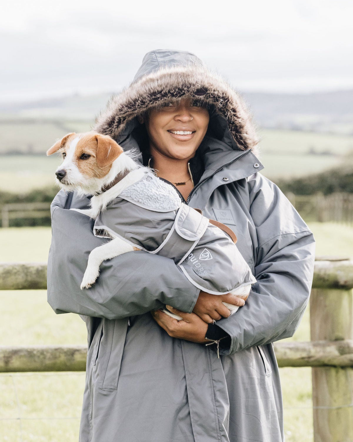 EQUIDRY: Woman & dog in matching grey waterproof coats. Dog in EQUIDRY waterproof coat with fleece lining & harness access
