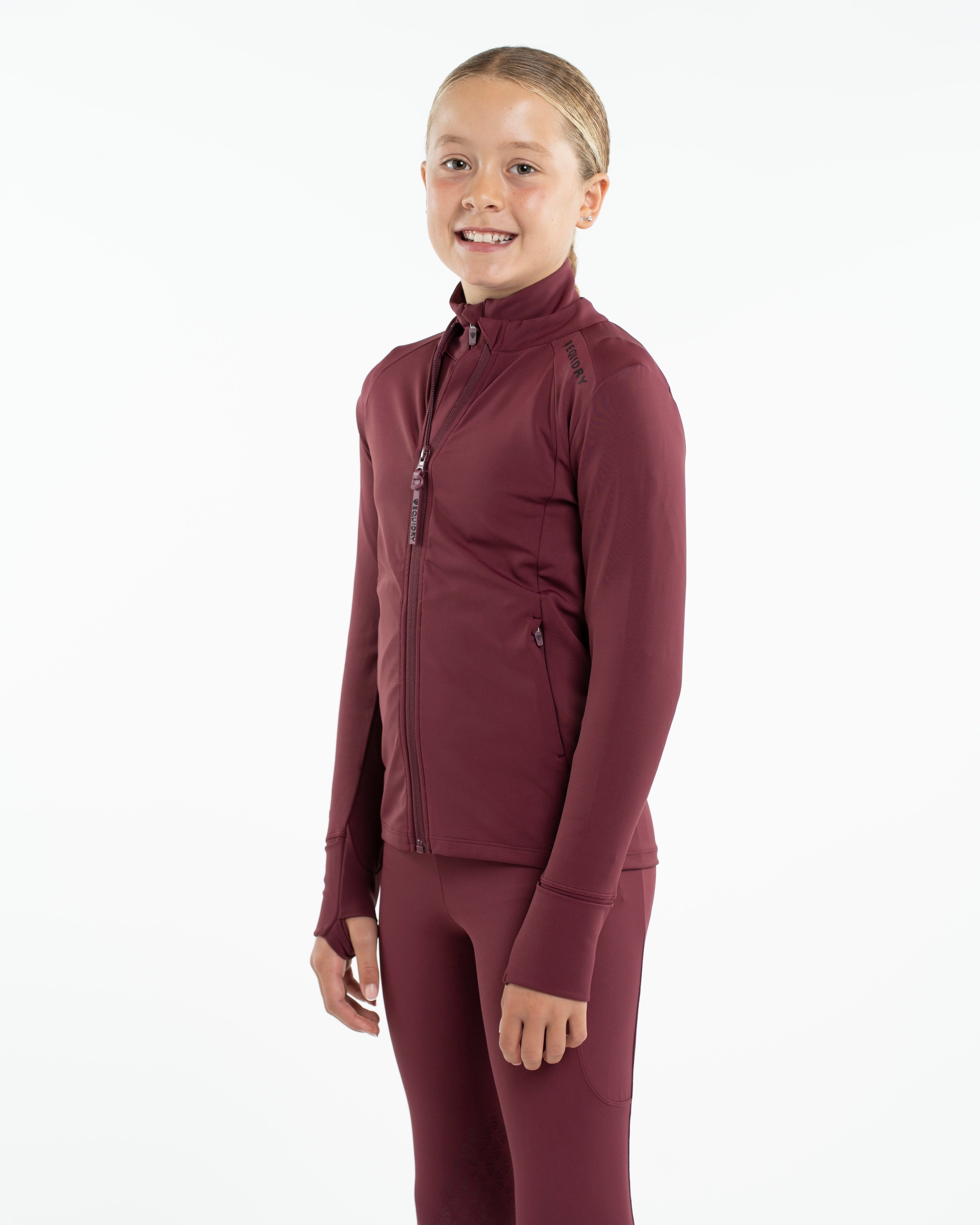 EQUIDRY Children's Water Repellent Zip Up Top Plum/Black by Equiflair. Girl wearing riding jacket.