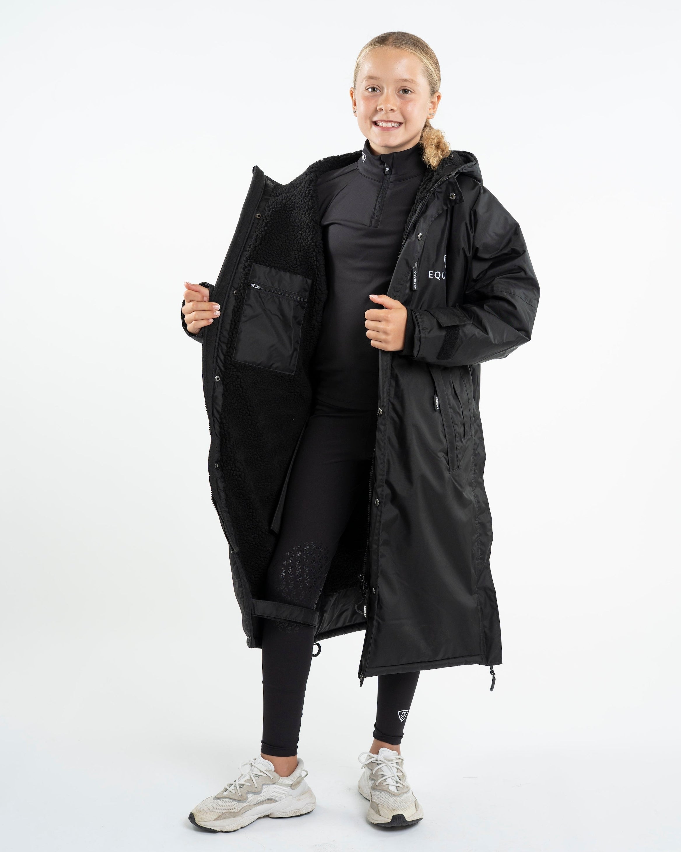 Girl in EQUIDRY EVOLUTION Children's Black Fleece Coat: Waterproof Equestrian Outerwear