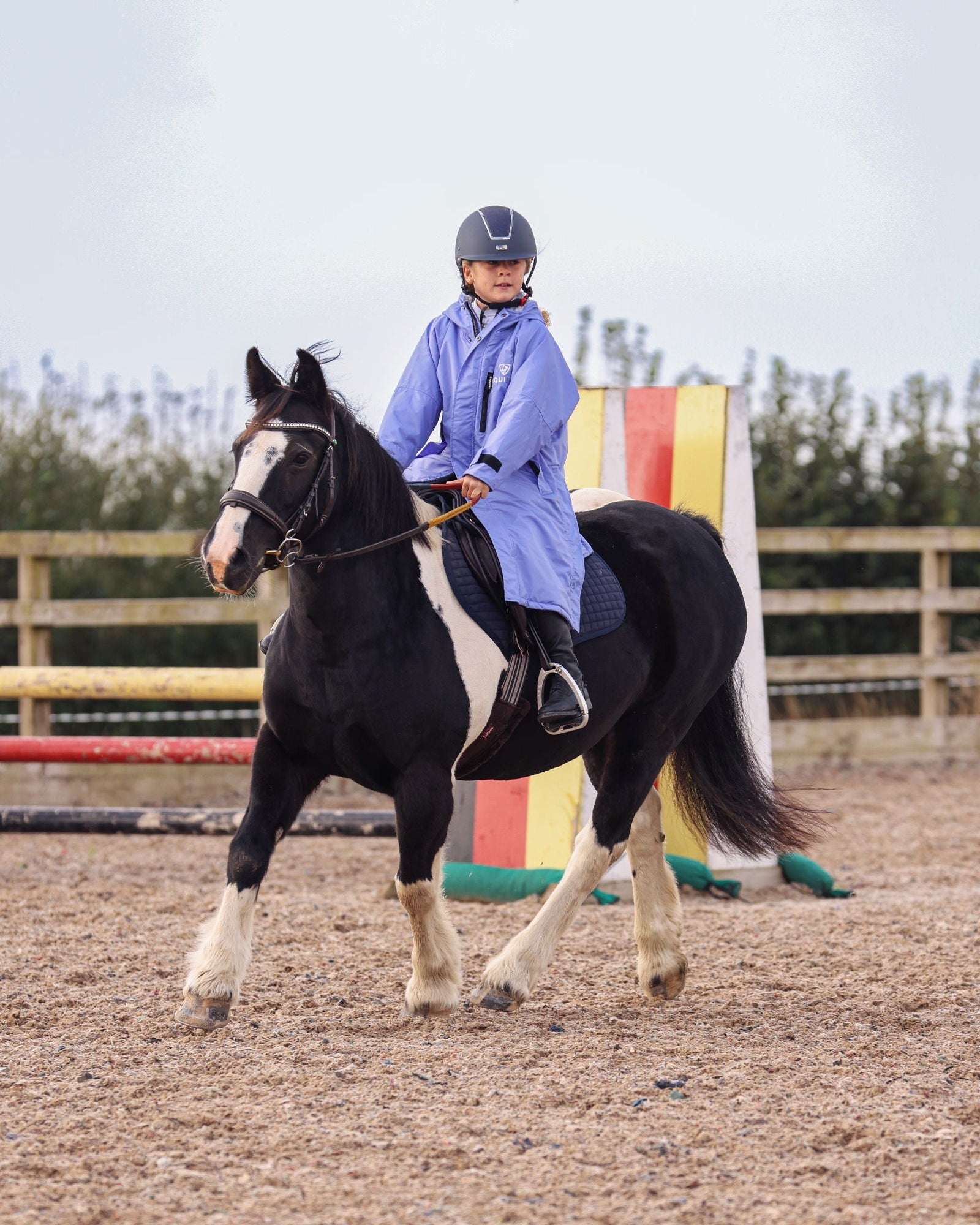 Kids Horse Riding: Child on Horse in EQUIDRY Waterproof Fleece Jacket. Blue/Lilac Equestrian Coat
