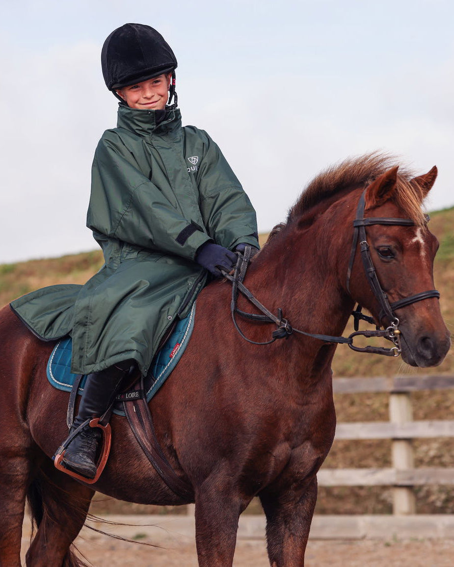 Child Equestrian Riding Coat - Waterproof & Warm. Black Forest Green Fleece-Lined EQUIDRY Evolution Coat on Horse.