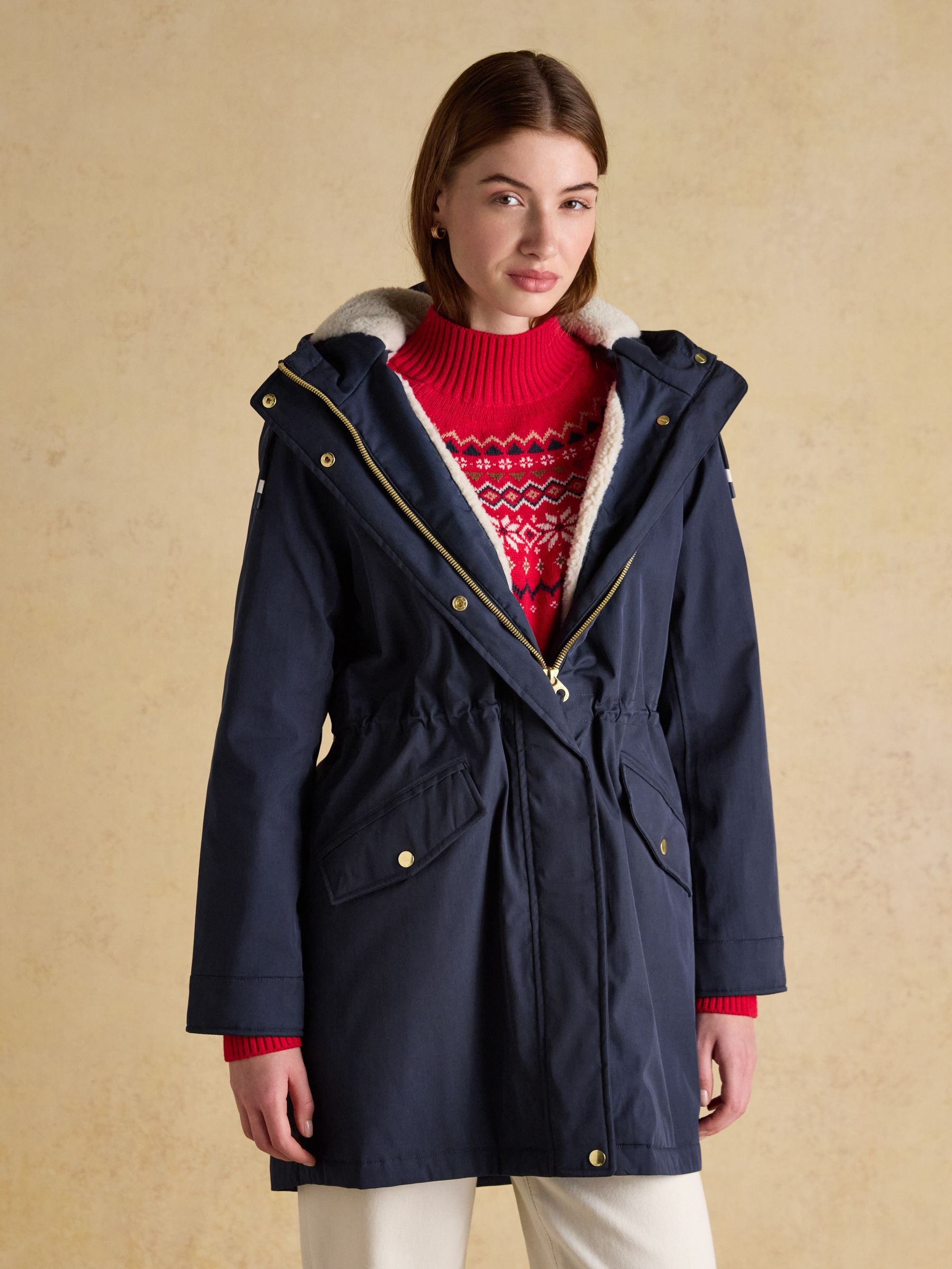 Women's navy blue Joules fleece-lined waterproof parka with hood and fair isle sweater detail.