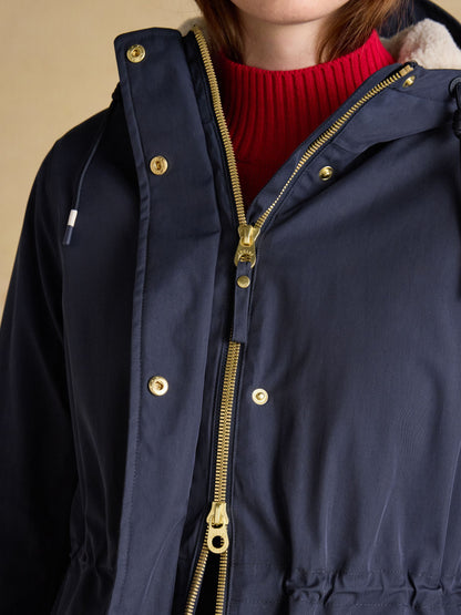 Navy blue Joules fleece-lined waterproof raincoat with hood and gold zipper detail