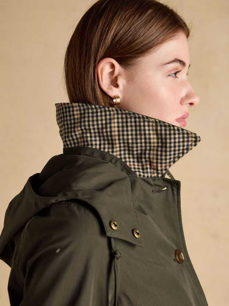 Joules Rainmore Khaki Green Waterproof Raincoat: Woman in green Joules hooded raincoat with a stylish checked collar. Equiflair product.