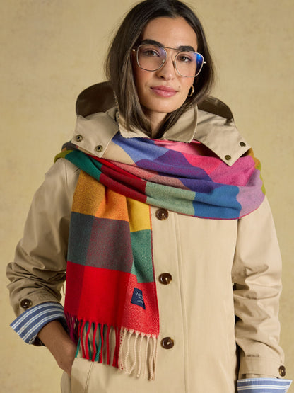 Women's Joules colorful plaid scarf styled with a beige trench coat, a cozy and stylish fashion accessory