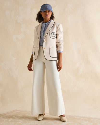 Woman wearing Joules Daley Cap, blazer, striped shirt, wide-leg trousers and heels. Fashionable lifestyle clothing from Equiflair.