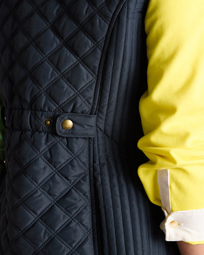 Joules Minx Quilted Gilet Navy: Showerproof diamond quilted vest, perfect for layering and outdoor activities. Shop Equiflair.
