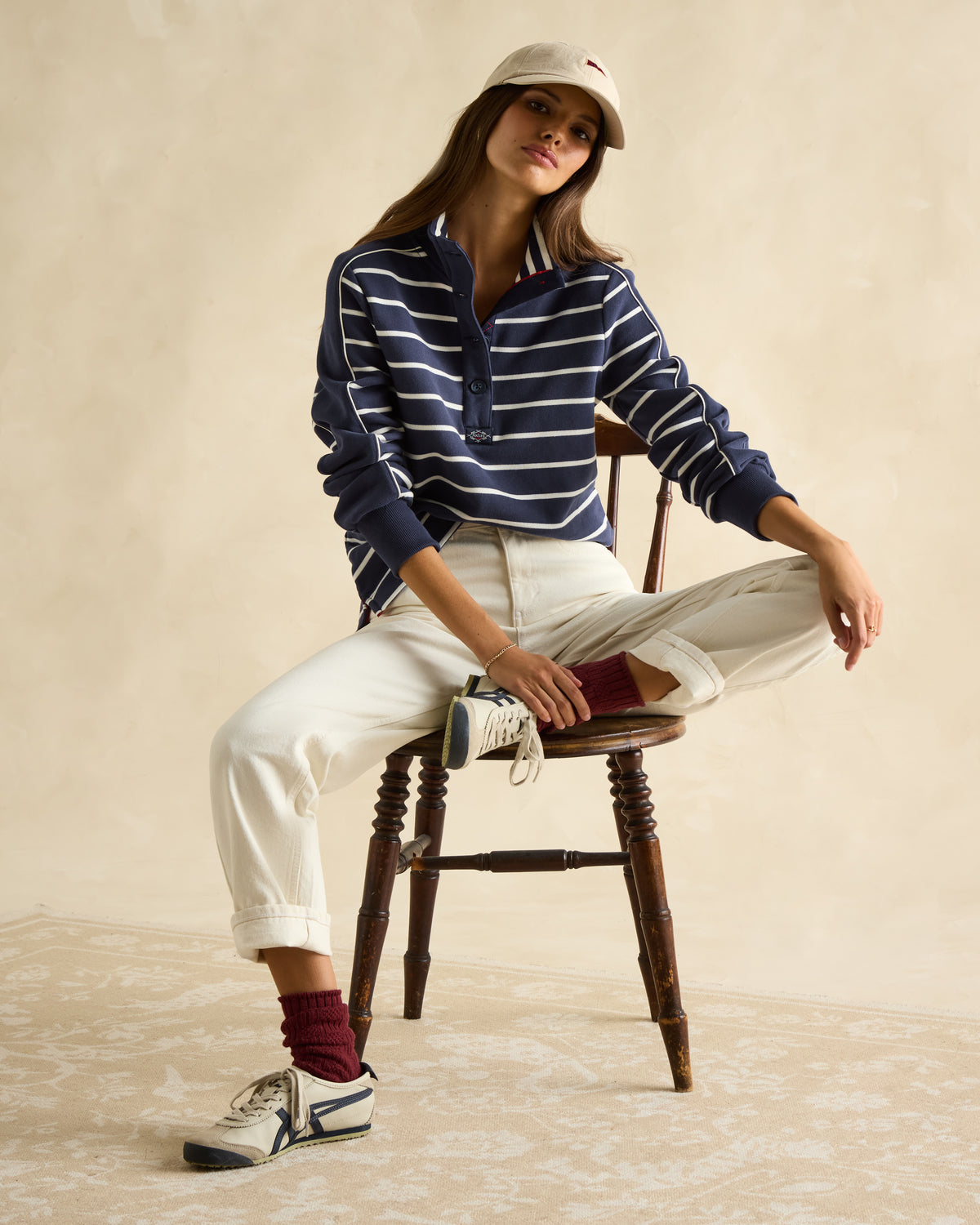 Joules Southwold Navy Striped Sweatshirt: Woman in stylish button-down shirt & casual outfit by Equiflair. Coastal-inspired fashion.