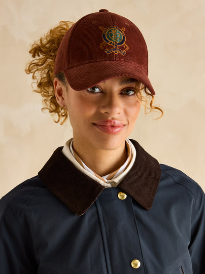 Joules Katherine Waterproof Coat Navy: Woman in Corduroy Cap and Country Style Jacket with Corduroy Collar and Gold Buttons