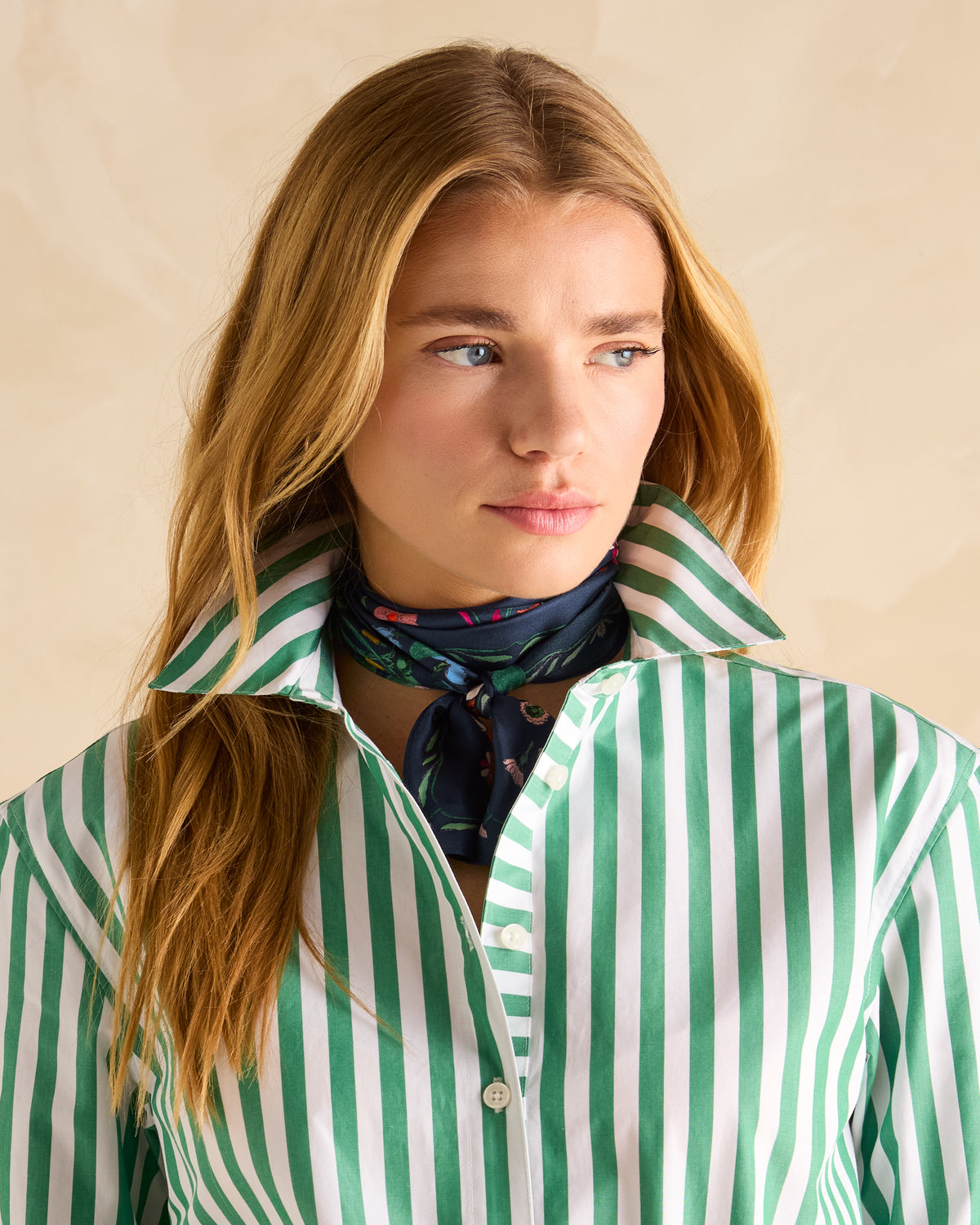 Joules Highgrove Navy Floral Silk Scarf - Equiflair: Woman wearing floral scarf and green striped shirt.