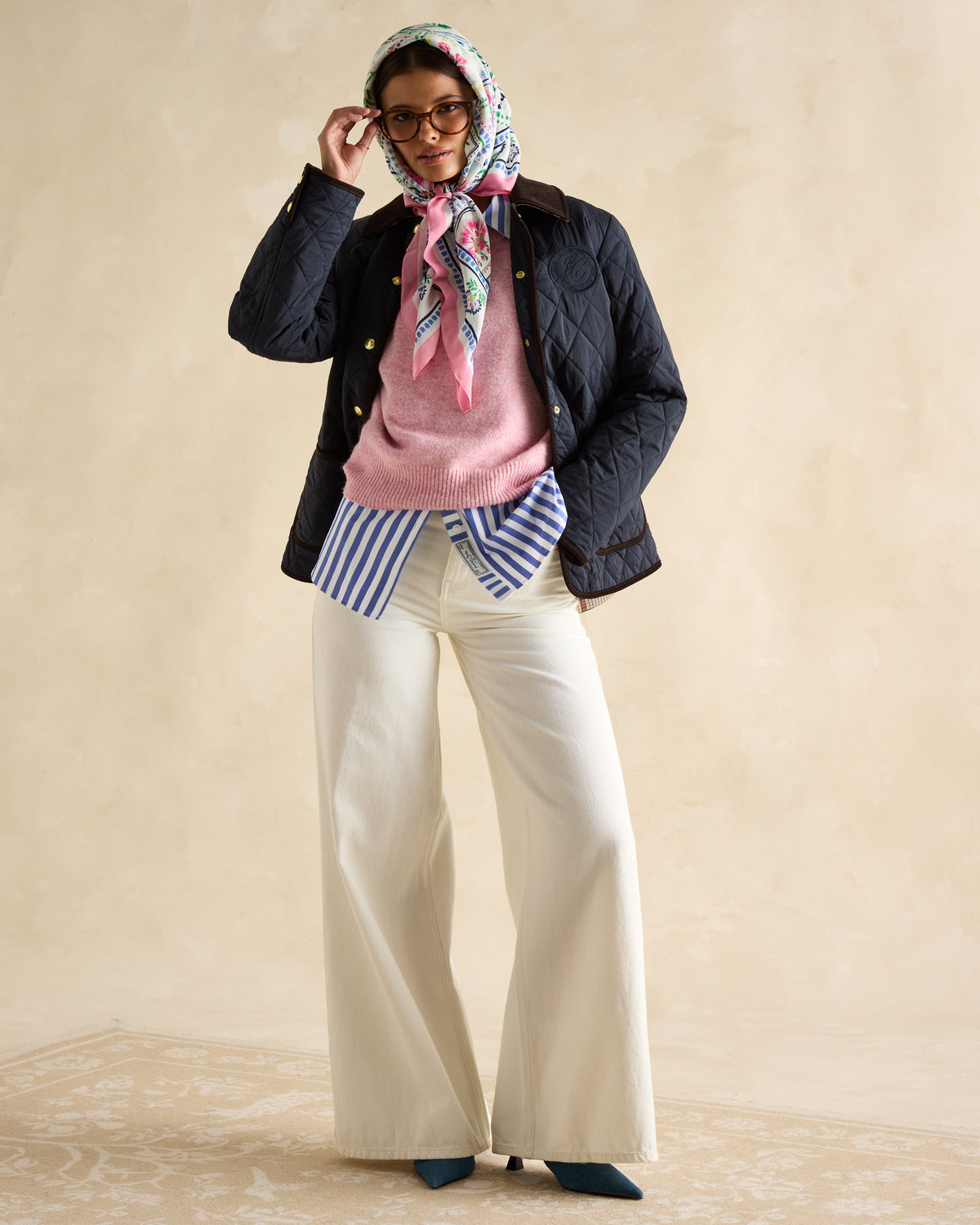 Woman wearing JOULES Quinn Navy Diamond Quilted Jacket from Equiflair. Stylish outerwear fashion.