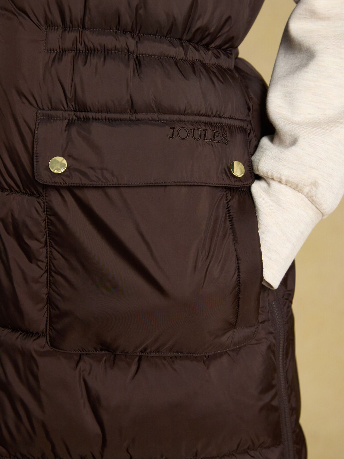 Women's Joules chocolate brown longline puffer vest, showerproof padded gilet for outdoor wear.