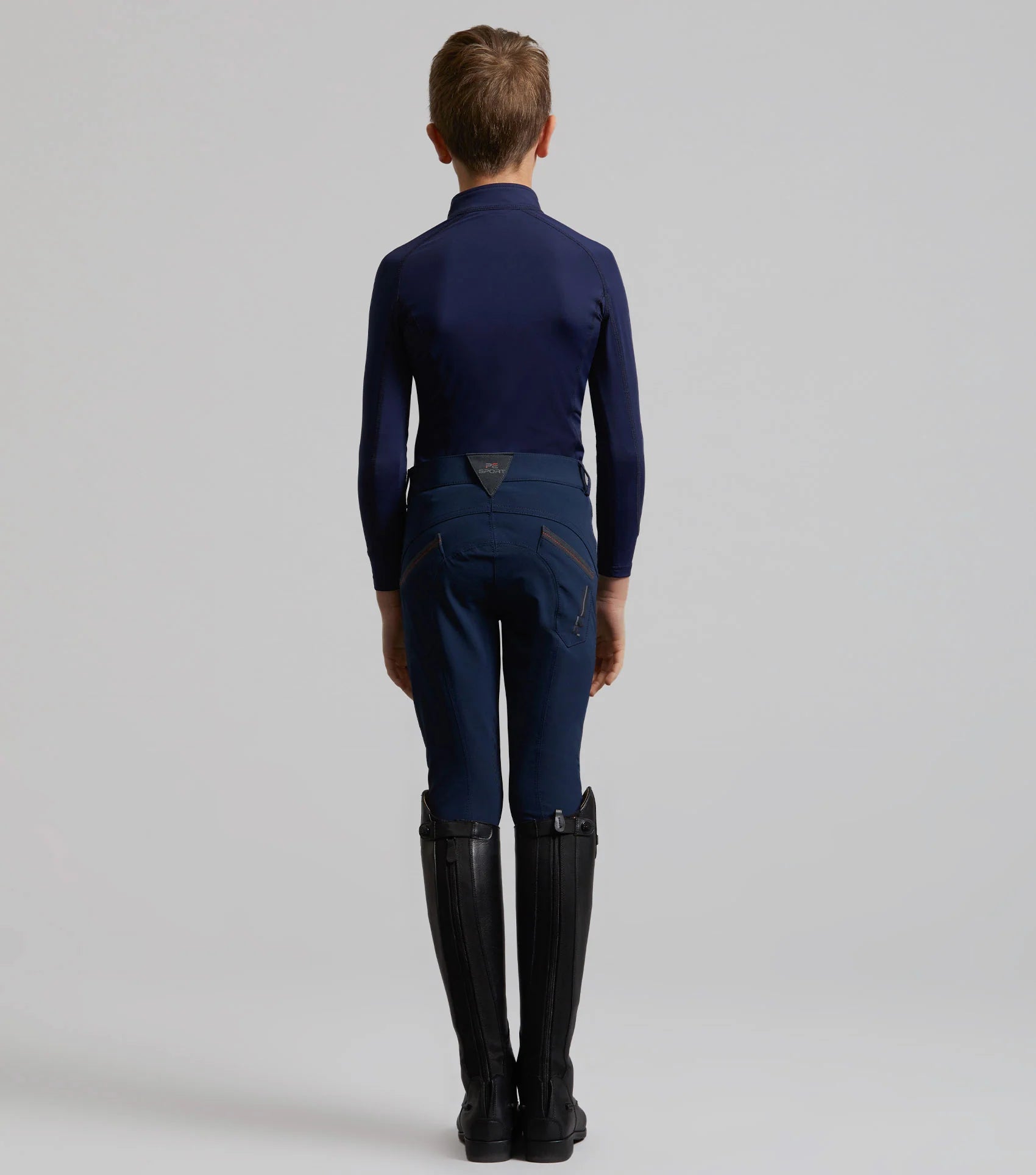 Premier Equine Gando Boys Gel Knee Riding Breeches Navy. Stylish & comfortable equestrian apparel for young riders.