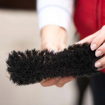 BORSTIQ Soft Flick Brush horse grooming brush held by hands