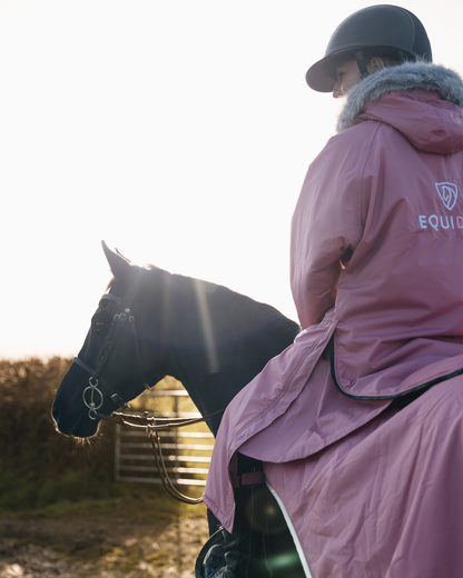 EQUIDRY Evolution Lux Women's Warm Waterproof Winter Horse Riding Coat Thick Fleece Lining with Faux Fur Trim Hood dusky pink on horse with matching exercise sheet