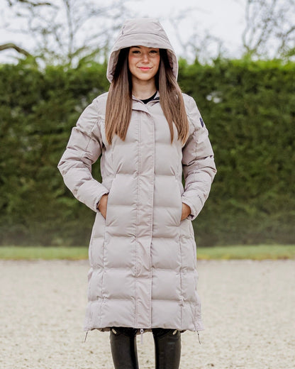 EQUIDRY THORA Waterproof Riding Puffer Coat Women's Sand - Equiflair. Lightweight, warm, and stylish winter equestrian coat with hood.