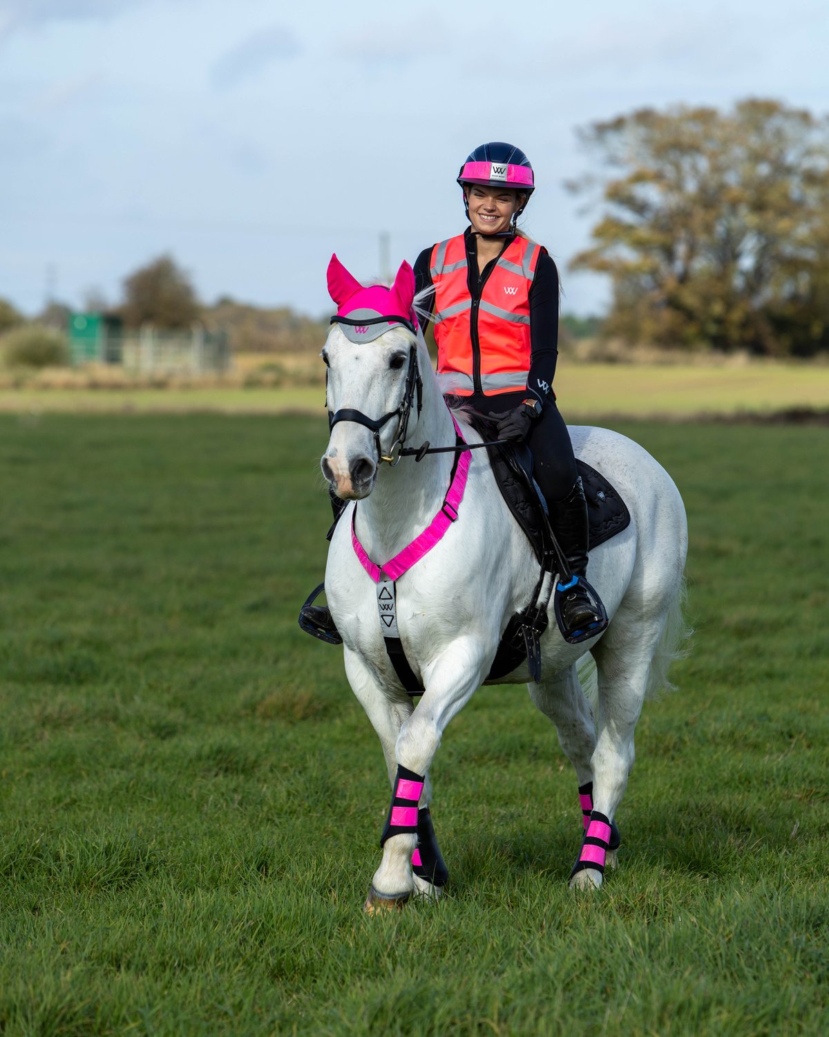 Horse Rider in Woof Wear Hi Vis Pink Safety Gear: Reflective Vest, Helmet, Leg Wraps