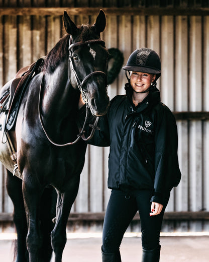 EQUIDRY women's waterproof short blouson style horse riding jacket in black/black with horse on yard