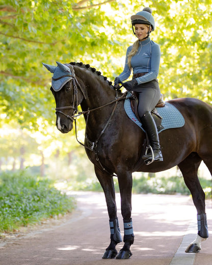 Horse and rider in LeMieux Ice Blue Suede Close Contact Square from Equiflair: Equestrian Style