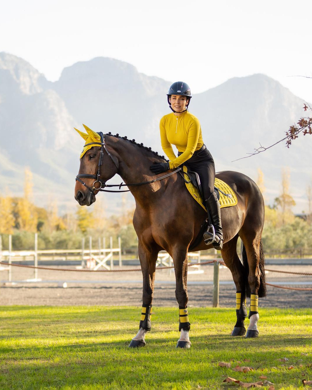Woman riding horse wearing LeMieux Loire Dijon saddle pad from Equiflair. Equestrian style, horseback riding gear.