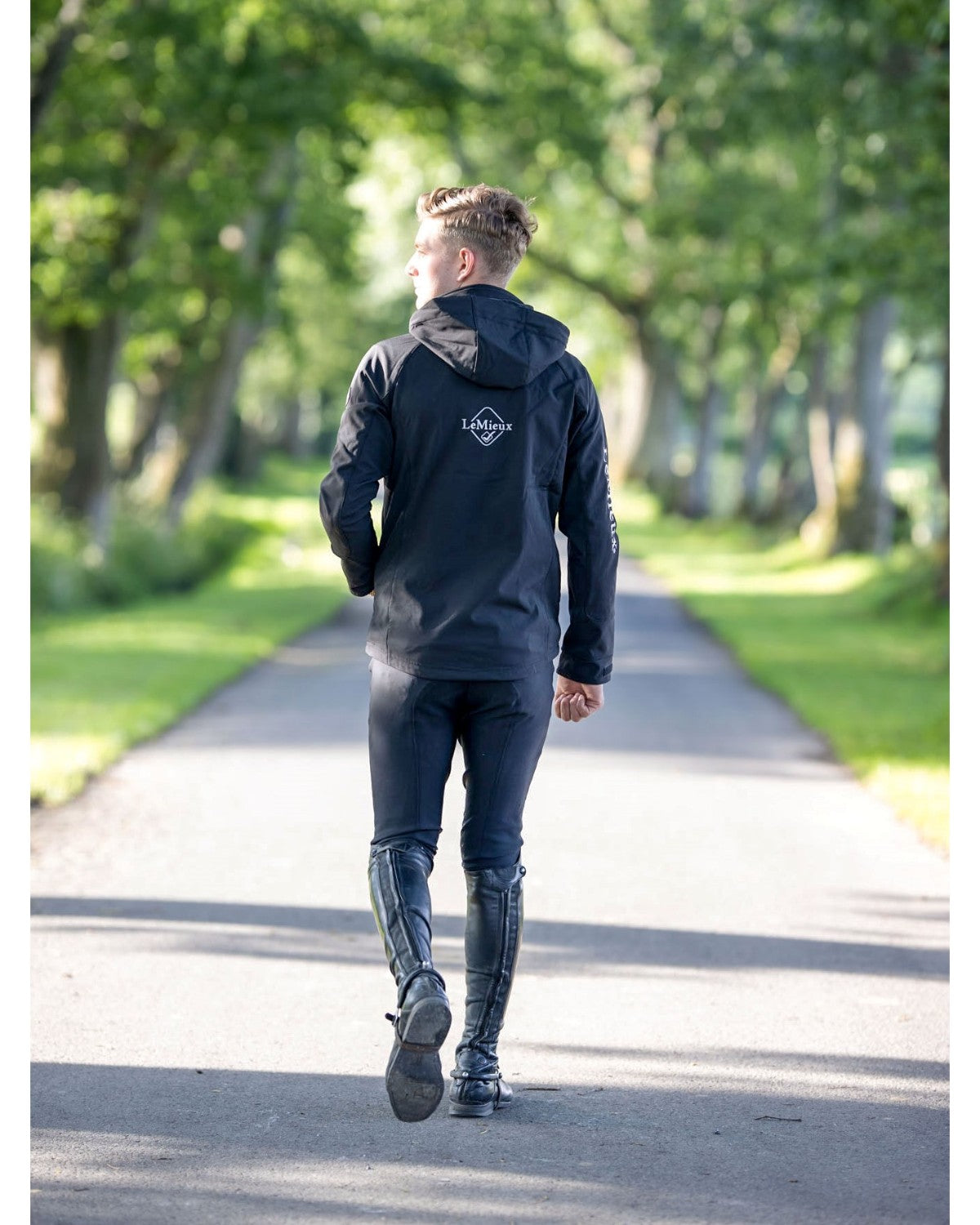 LeMieux Mens Elite Soft Shell Jacket Black - Equiflair Equestrian Apparel, Rider Walking on Path
