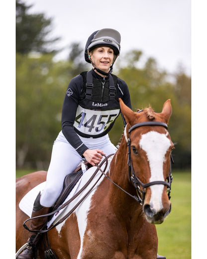LeMieux Eventing Bib Black: Horse Rider with Competition Number 445 on Brown Horse
