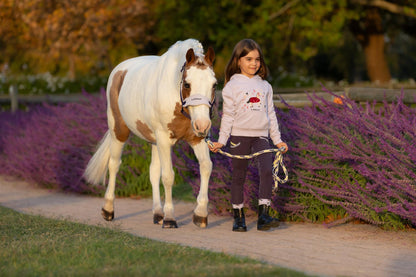 Girl with pony wearing LeMieux Juniper Headcollar. Equiflair store. Stylish, soft fleece horse headcollar for comfort.