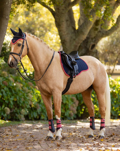 LEMIEUX SUEDE GP SQUARE NAVY/CRANBERRY Saddle Pad on Horse. Equestrian gear from Equiflair.