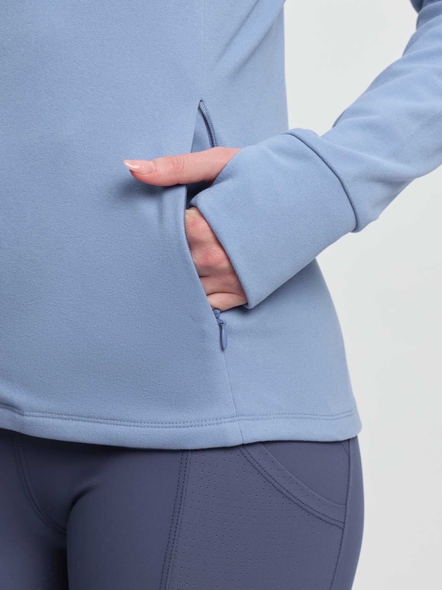 LeMieux Frances Quarter Zip Fleece Powder Blue: Women's athletic fleece jacket with thumbholes and quarter-zip design.