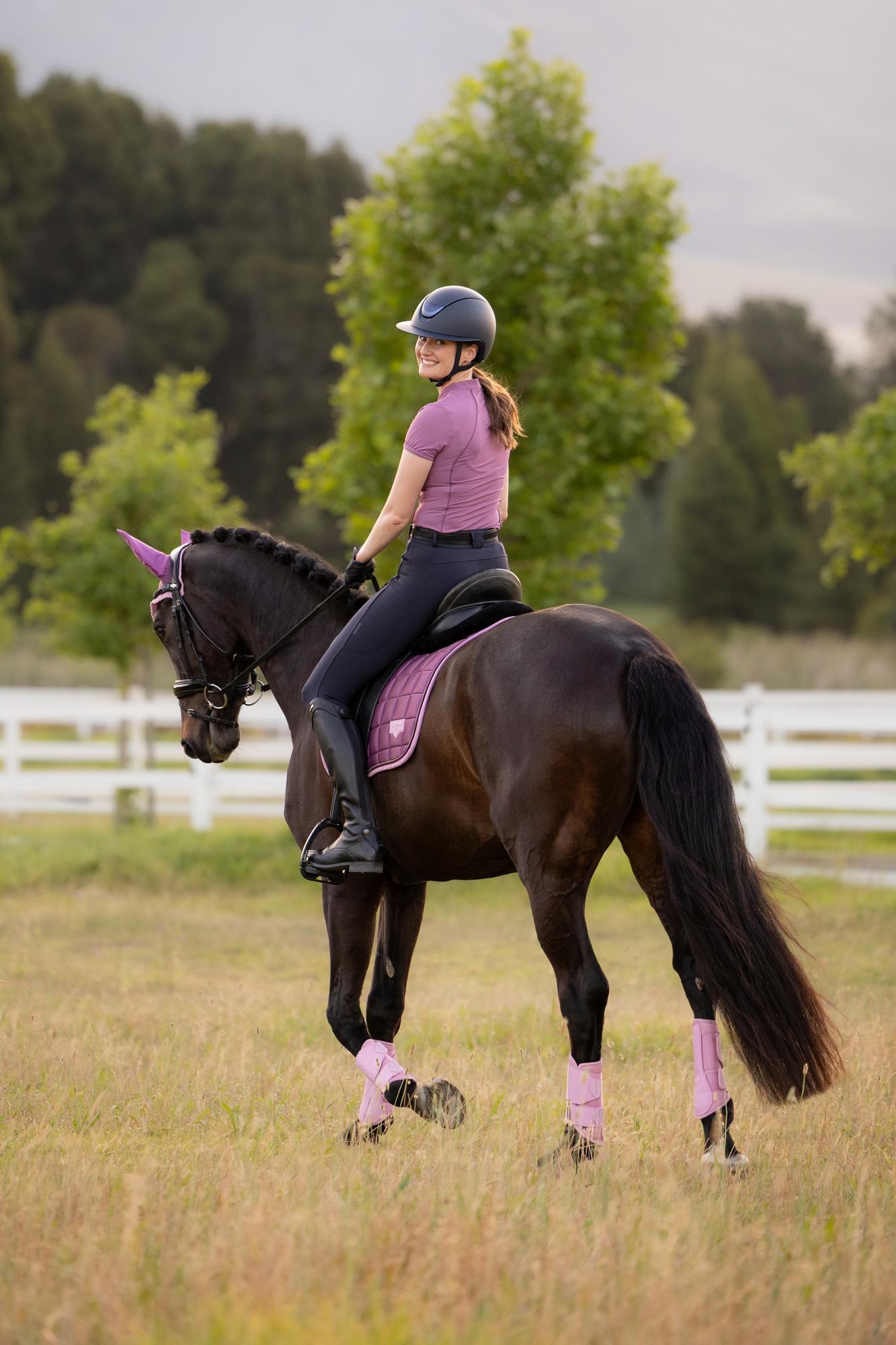 Equestrian rider on horse with LeMieux Loire Classic Dressage Square Saddle Pad in Mallow. Horse riding gear from Equiflair.
