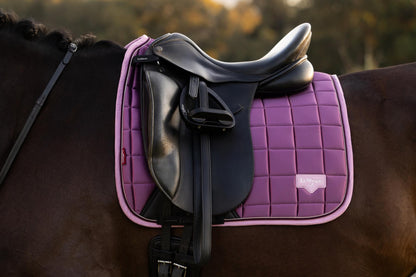 LeMieux Loire Classic Dressage Square Mallow saddle pad on horse, stylish equestrian equipment for horse riding with luxurious satin