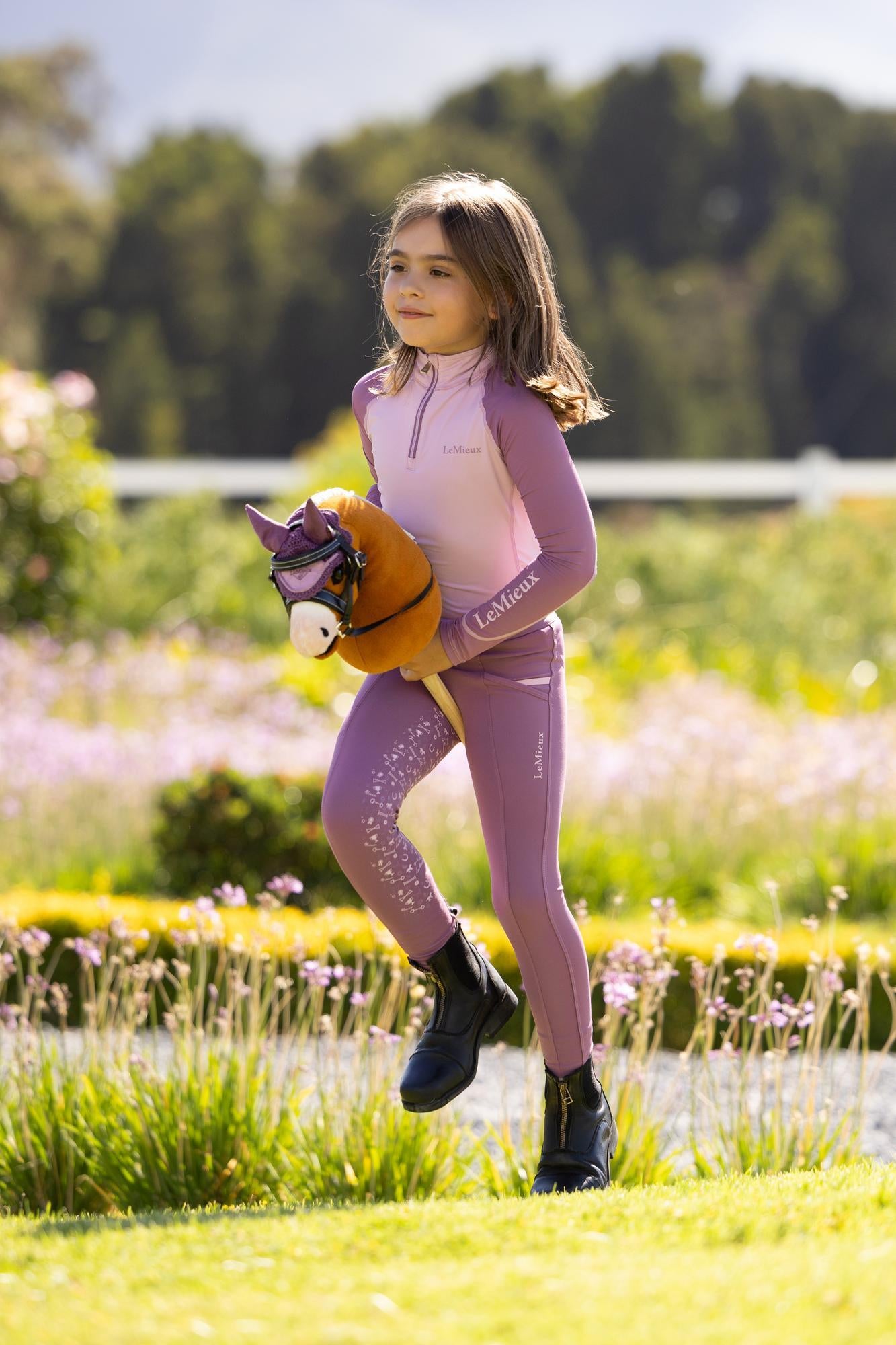 Child riding LeMieux Hobby Horse Mini Sundance toy pony