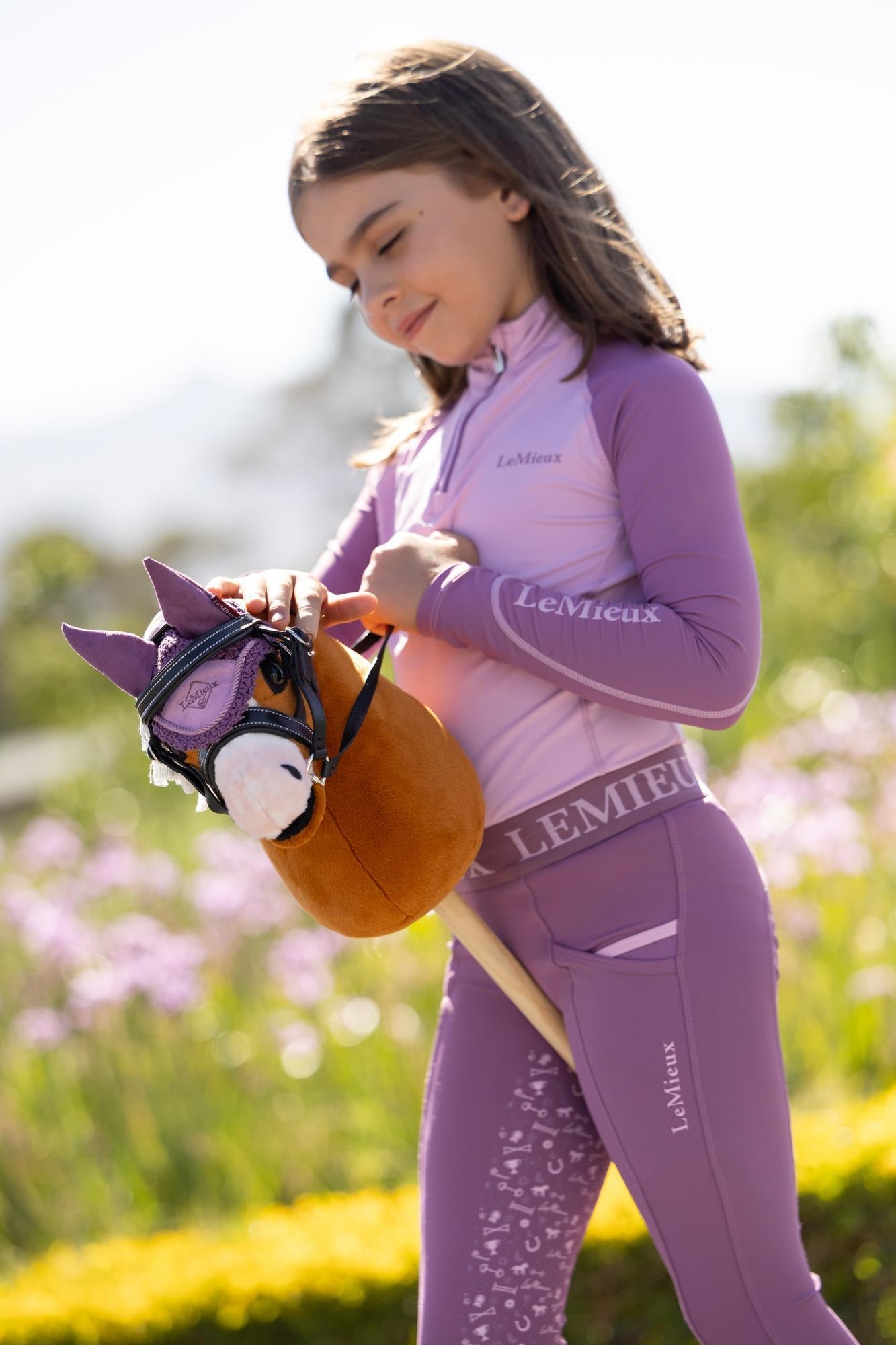 Child riding LeMieux Hobby Horse Mini Sundance toy pony