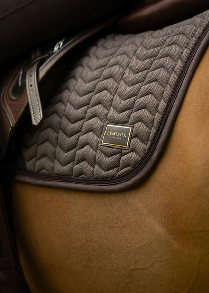 Brown LeMieux Heritage Herringbone Jump Square saddle pad on a horse, close-up of equestrian tack.