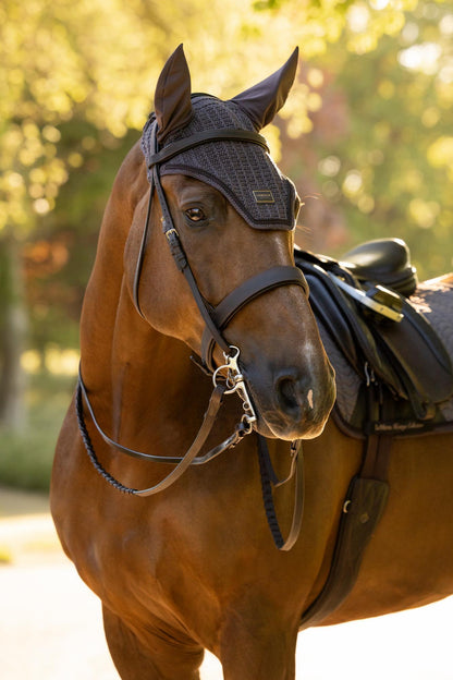 Brown horse wearing LeMieux Heritage fly hood in cocoa with dark bridle and saddle