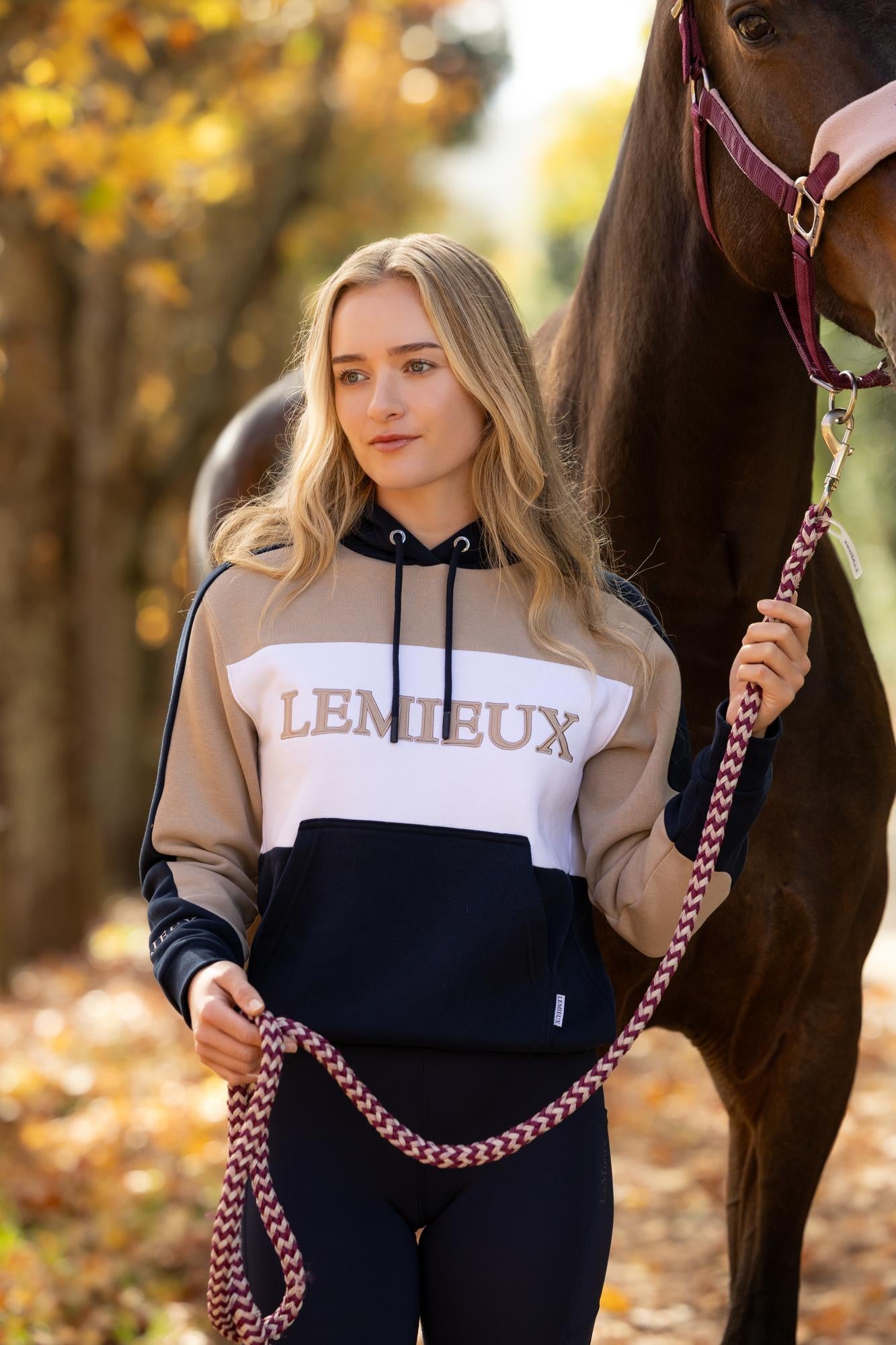 LeMieux navy color block hoodie worn by a woman with a horse, equestrian style
