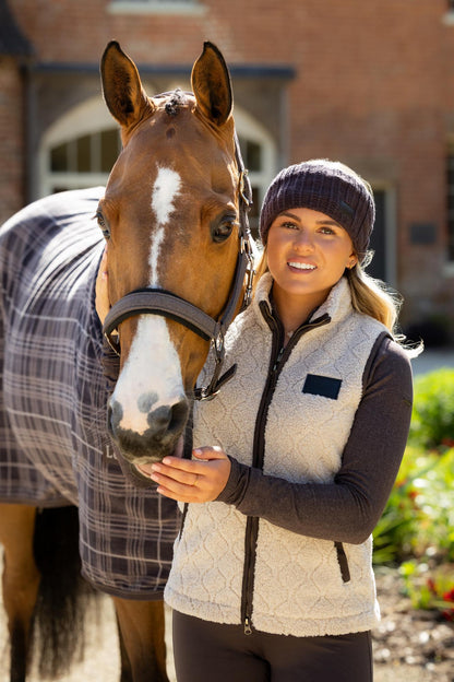 LeMieux Heritage Borg Gilet in Stone worn by a woman with a horse