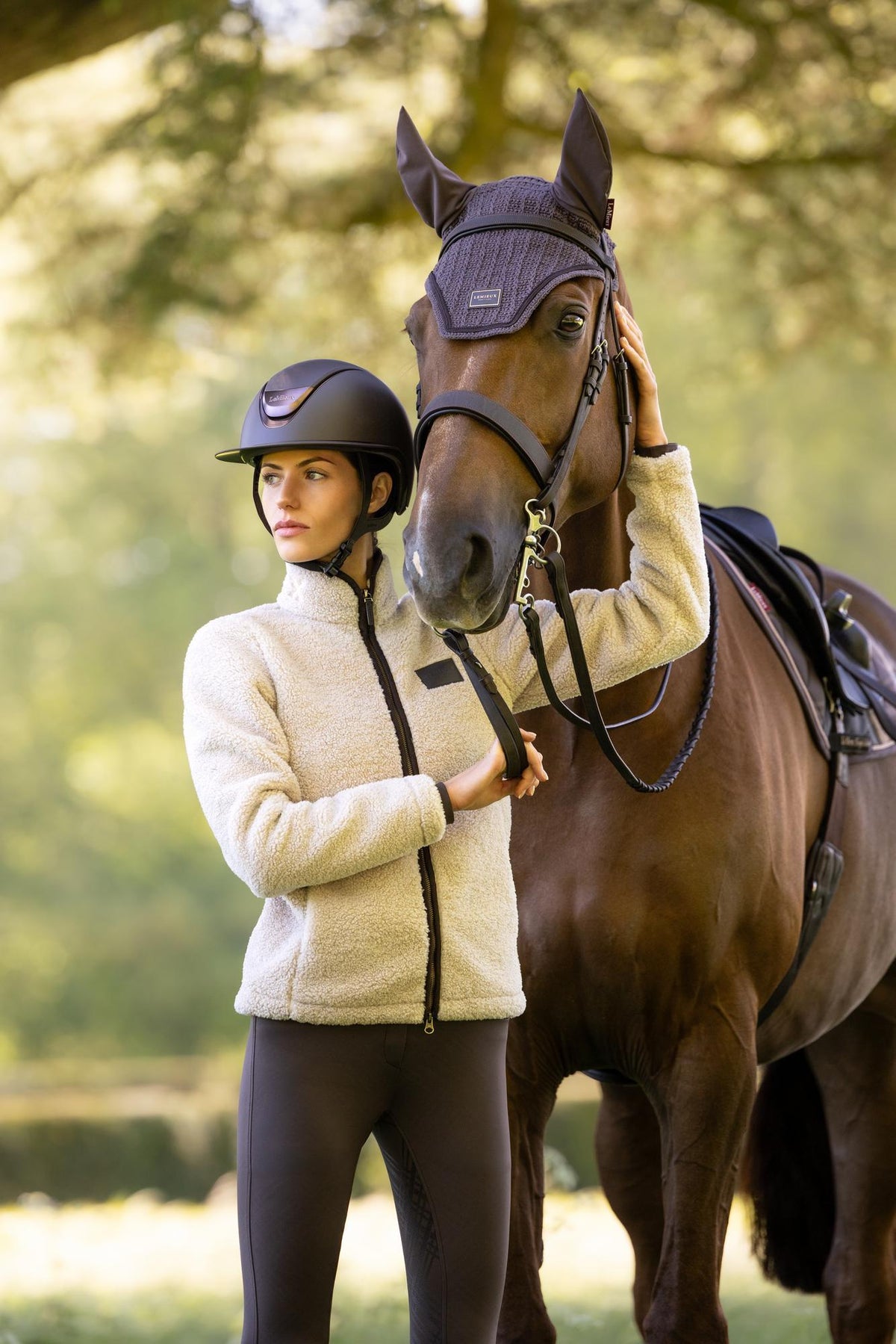 LeMieux Heritage Borg Zip Through Jacket Stone worn by a rider with a horse.