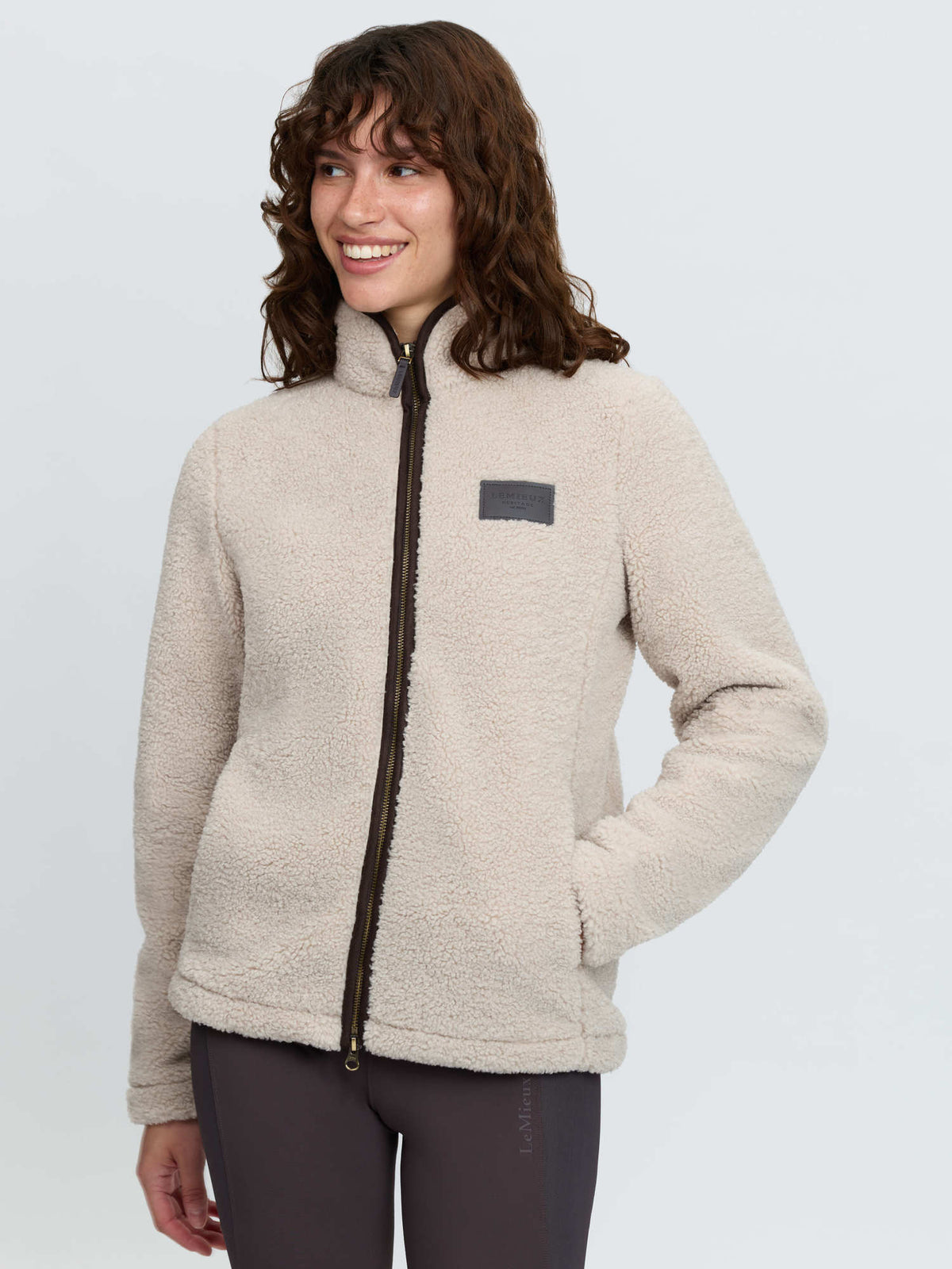 LeMieux women's stone color borg fleece jacket with full zip and faux leather badge.
