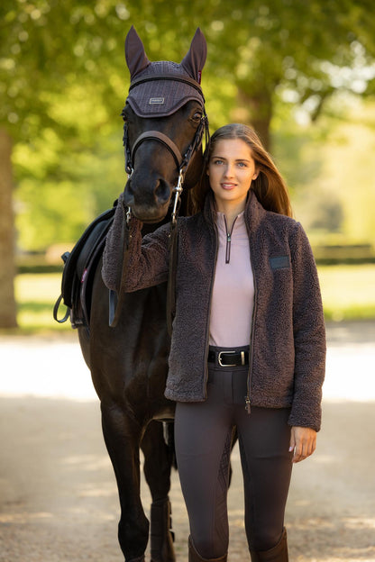 Woman in LeMieux Heritage Borg Zip Through Jacket Cocoa with horse, equestrian apparel.