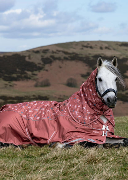 LeMieux Arika Star Turnout Rug 0G in Spiced Earth, waterproof breathable rug on a white horse lying down.