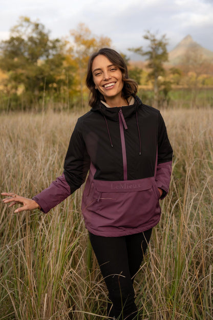LeMieux Phoebe Half Zip Waterproof Anorak in Black/Bramble worn by a woman outdoors.