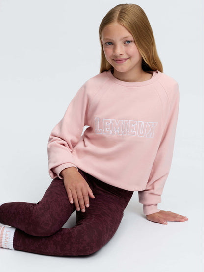 LeMieux young rider pink varsity crew neck sweatshirt and burgundy patterned leggings on a girl.