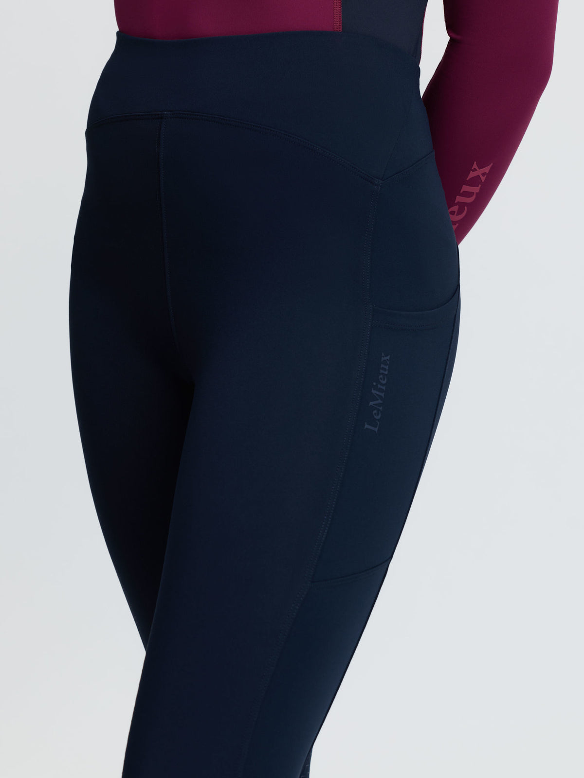 LeMieux navy riding leggings with side pocket and subtle logo, worn by a young rider.