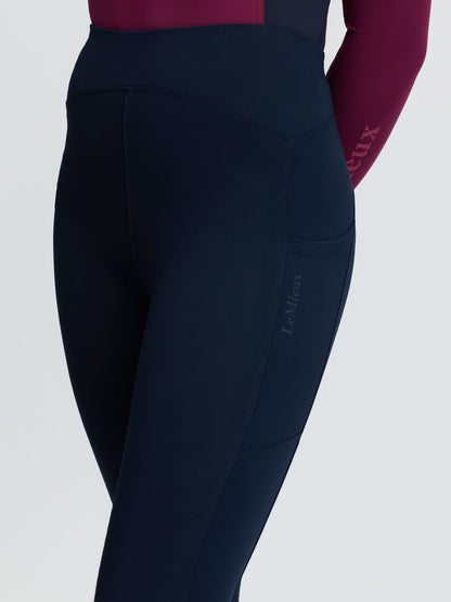 LeMieux navy riding leggings with side pocket and subtle logo, worn by a young rider.