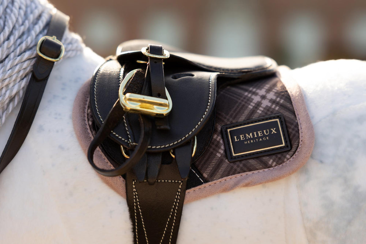 LeMieux toy pony saddle pad with Heritage check pattern and gold logo badge. Close-up.