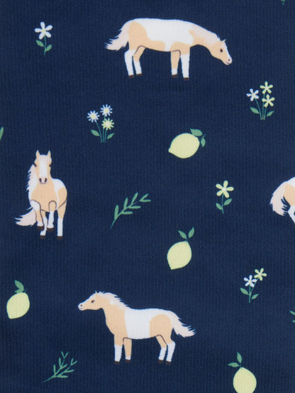 Navy blue footsie socks with a fun pattern of horses, lemons, and flowers.