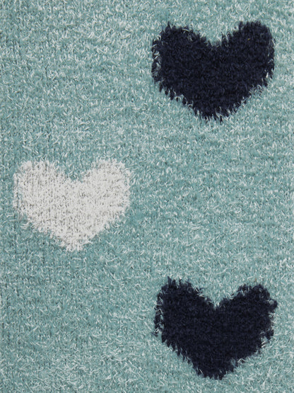 Close-up of LeMieux Heart Fluffies Aloe socks featuring teal fabric with navy and white heart patterns