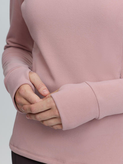 Women's pink LeMieux Frances quarter zip fleece with thumbholes for active wear and layering.